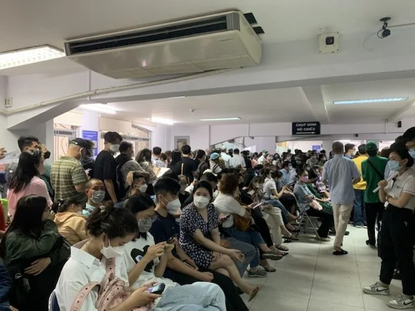 Long-line-of-people-waiting-at-a-government-office-counter