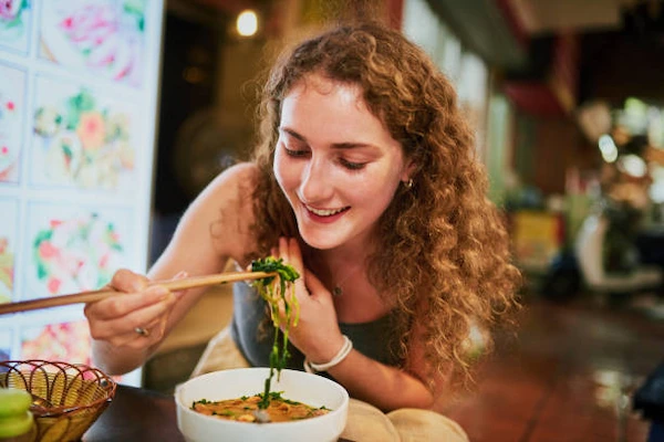 Person-enjoying-a-delicious-bowl-of-phở-at-a-local-restaurant