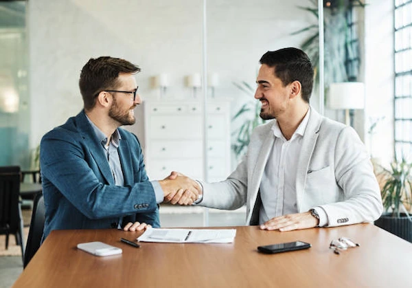 Businessperson-smiling-and-shaking-hands-with-a-colleague-after-a-successful-negotiation