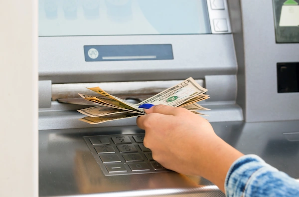 foreign-worker-using-bilingual-atm-to-withdraw-cash