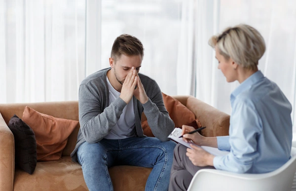 Therapist listening attentively to client - supportive environment - counseling session