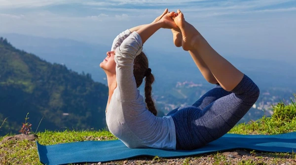 Person doing yoga poses on a mat - yoga practice - flexibility workout