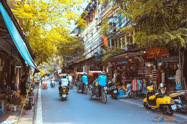  Crowded street scene in Hanoi with motorbikes, shops, and people - Vietnam street scene - vibrant energy