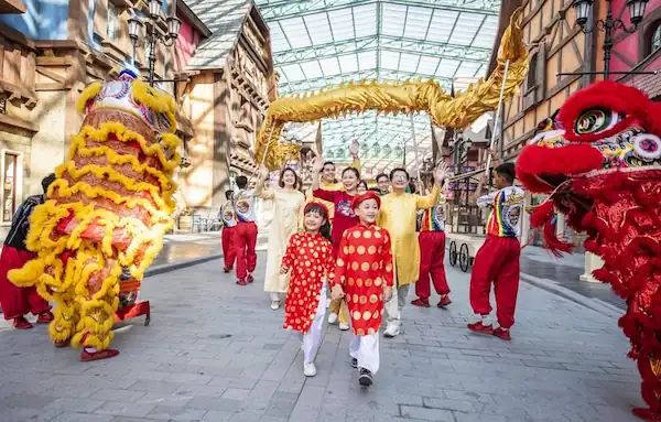 Lion dance performance in a public square filled with cheering crowds - Tet in Vietnam - lion dance celebration