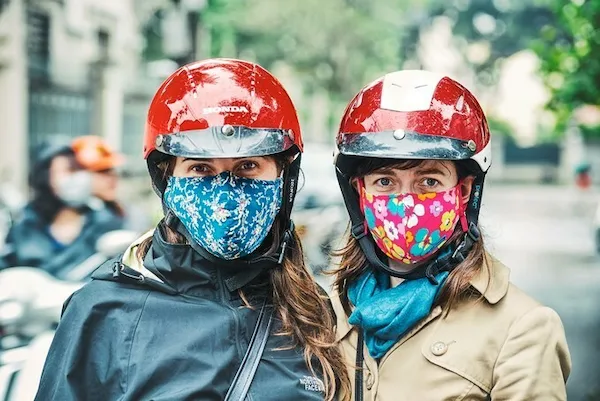 expat-wearing-mask-cycling-on-city-street 