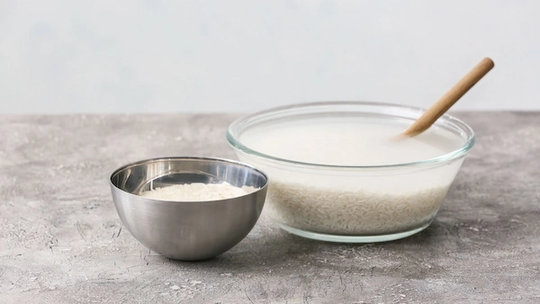 woman-washing-face-with-rice-water