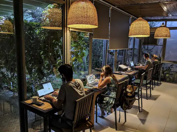 expat-working-at-modern-coworking-desk