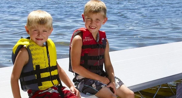 child-wearing-life-jacket-playing-at-beach