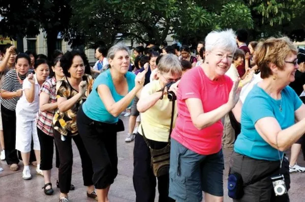 happy-tourists-taking-photos-with-locals-in-vietnam