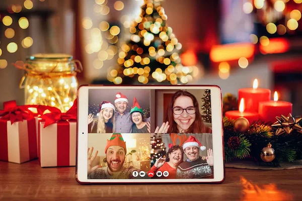 family-decorating-christmas-tree-together-video-call