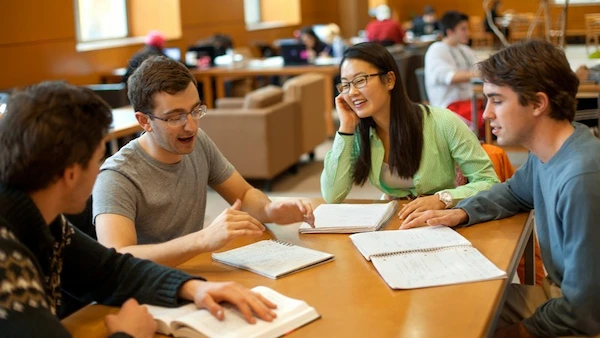 Person laughing and pointing at a Vietnamese textbook with another person - Vietnamese language partner - fun and engaging