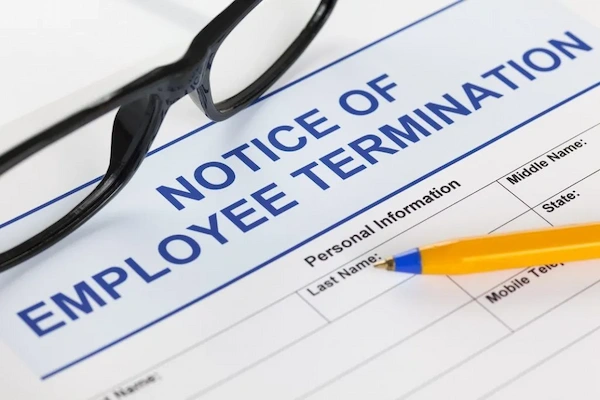 Person writing a letter on a desk - lease termination - written notice