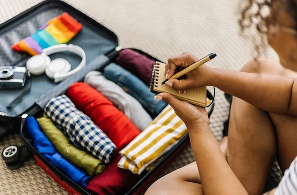 Suitcase filled with clothes - moving checklist - prioritize essentials